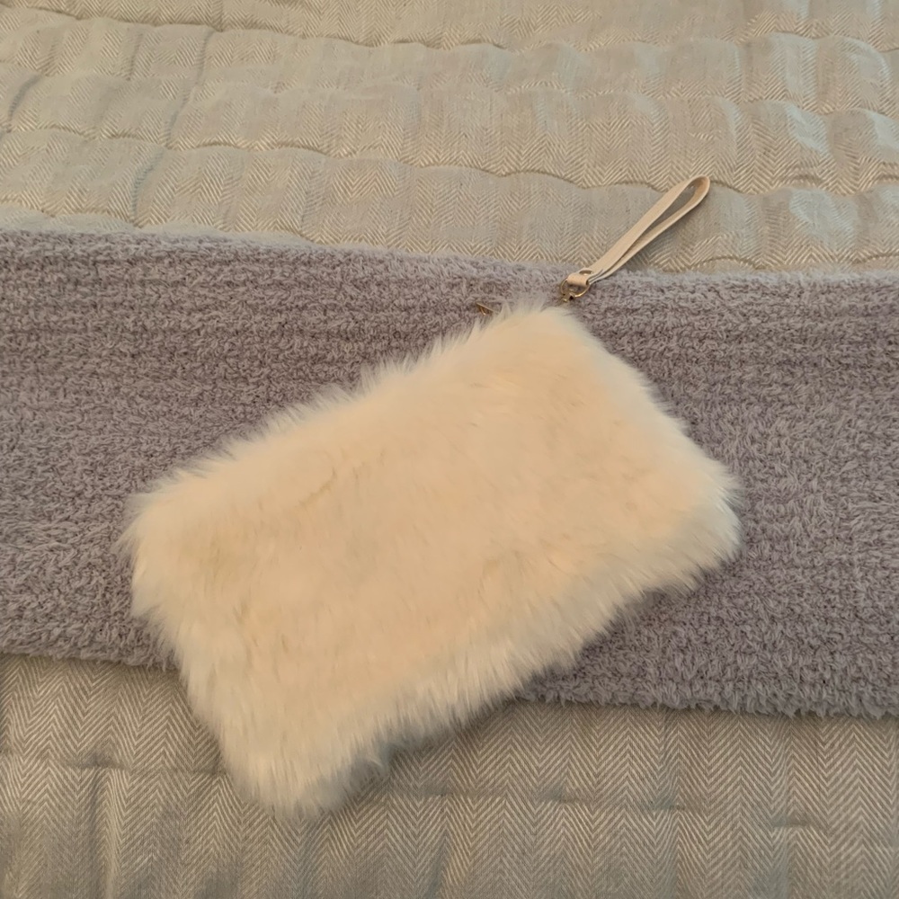 Ivory fuzzy clutch with wrist strap